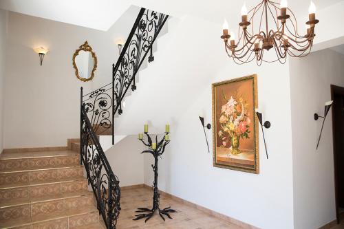 a staircase with a chandelier and a picture on the wall at Residenz Selena in Ustka