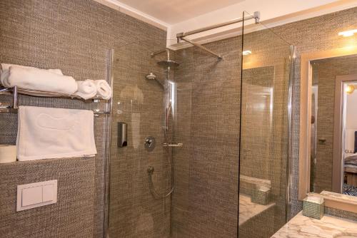 a bathroom with a shower with a glass door at ART Hotel in Sibiu