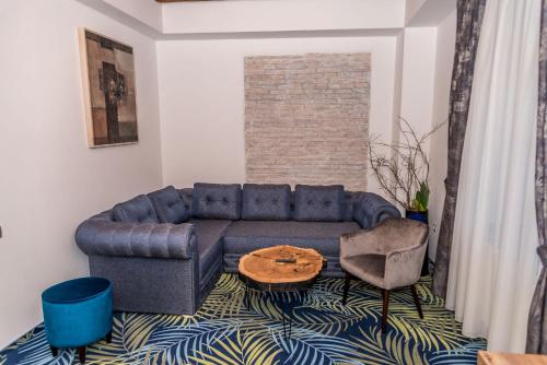 a living room with a blue couch and a table at ART Hotel in Sibiu