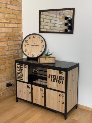 a clock sitting on top of a wooden cabinet at Sandra's Lounge in Klagenfurt