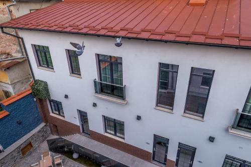 an aerial view of a white building with a red roof at ART Hotel in Sibiu