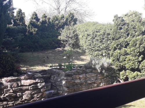 a view of a stone wall and trees at Apartment 144 in Kněževes