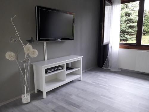 a living room with a flat screen tv on a wall at Apartment 144 in Kněževes