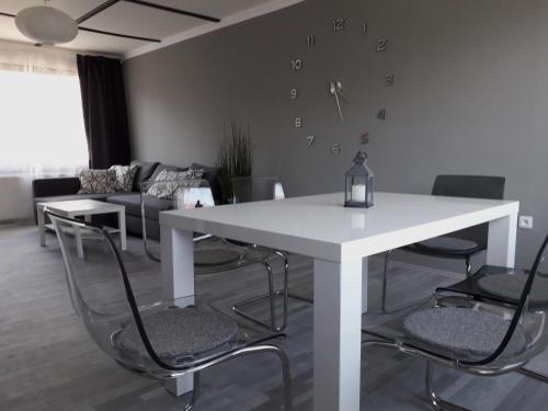 a white table and chairs in a living room at Apartment 144 in Kněževes