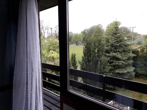 a window with a view of a field and trees at Apartment 144 in Kněževes