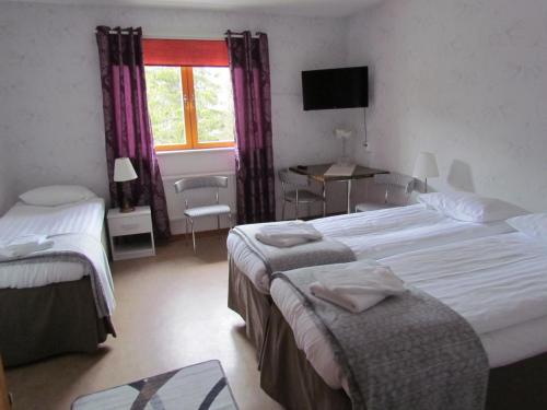 En eller flere senger på et rom på Ammarnäsgården Fjällhotell och Vandrarhem