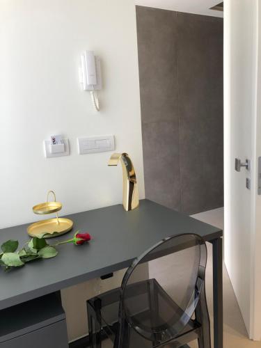 a kitchen with a desk with a flower on it at golden suites 50 in Monopoli
