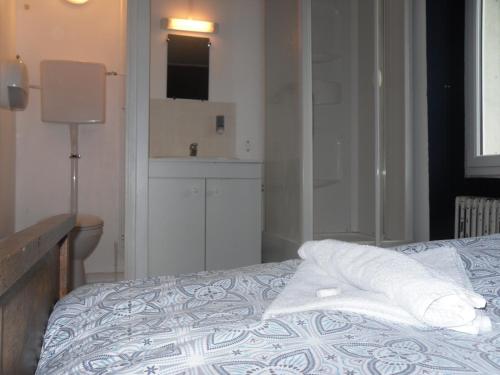 a bedroom with a bed with two pillows on it at l'escale gourmande in Châlus