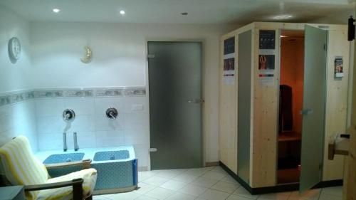 a bathroom with a sink and a toilet at Residence Bannwald in Valle Di Casies