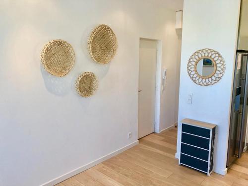 a room with three straw hats on a wall at Bright & modern apartment in the heart of Antibes in Antibes