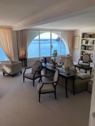 a living room with a table and chairs and a large window at Hotel Miramare & Spa in Sestri Levante