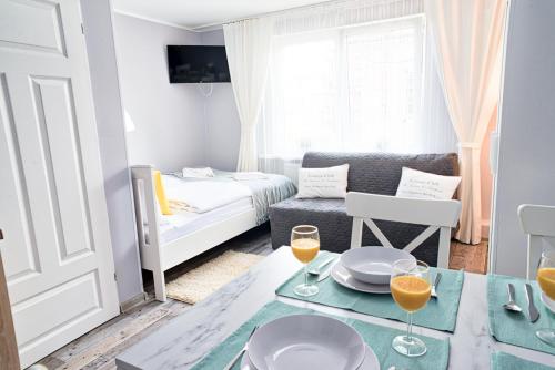 a small living room with a table and a couch at Morning Star Apartments in Międzyzdroje