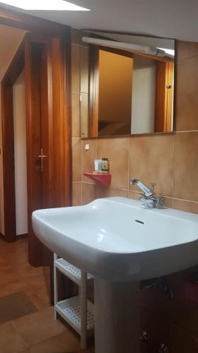 a bathroom with a white sink and a mirror at Residence Milena in Milano Marittima
