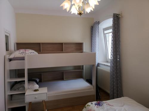 a bedroom with a bunk bed and a chandelier at Ipfmühle Studio 2 (Weizen) in Hargelsberg