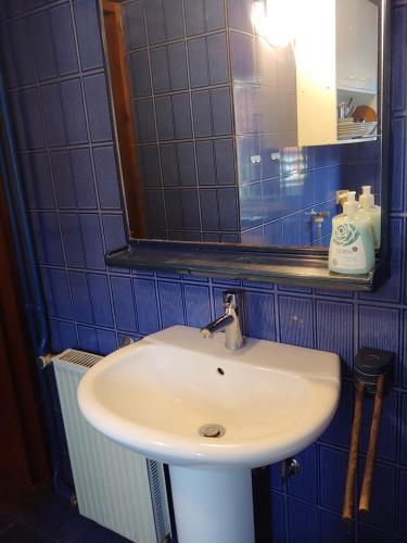a white sink in a bathroom with a mirror at Sobe Al Moletto in Koper