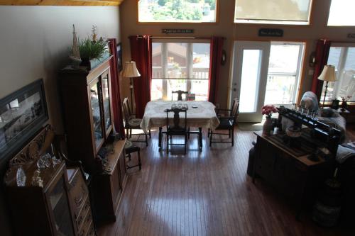 a living room with a table and a television at Sal's Bed and Breakfast by the Sea in Herring Cove