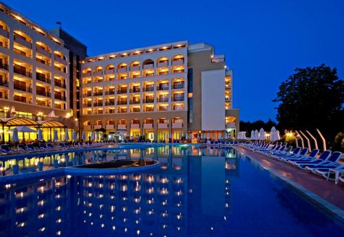 a hotel with a swimming pool at night at Sol Nessebar Mare All Inclusive in Nesebar