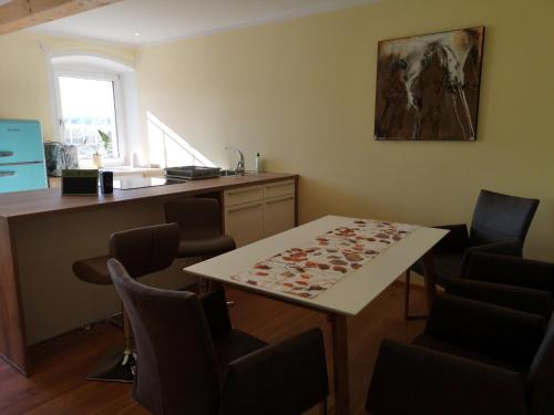 a room with a table and chairs and a counter at Apartment (4 Dinkel) in Hargelsberg