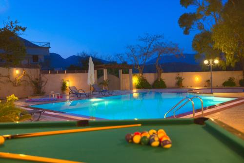 a pool table with balls on it in a swimming pool at Santalas Villa in Ágios Matthaíos