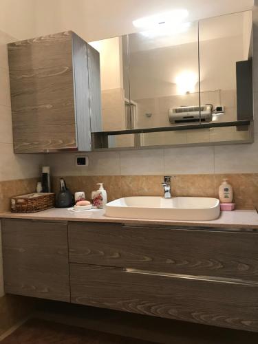 a bathroom counter with a sink and a mirror at B&B da Giorgia in Crodo