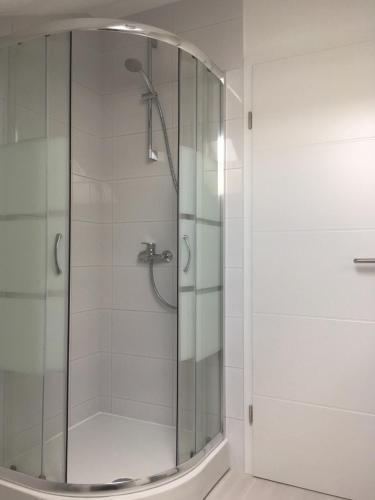 a shower with a glass door in a bathroom at Cambi 11 in Kaštela