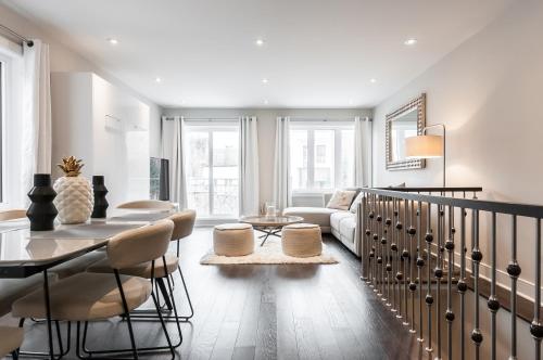 a living room with a table and a couch at Parc Avenue Lofts in Montreal