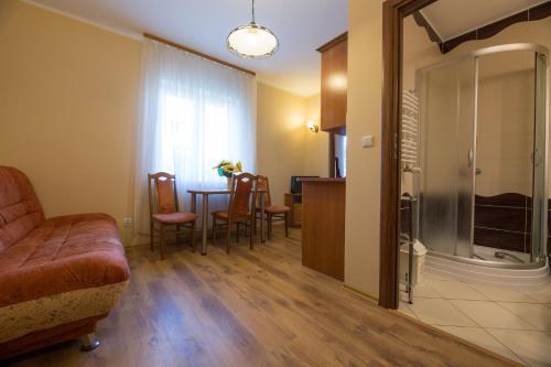 a living room with a couch and a table at Apartamenty Na Skarpie in Dębina