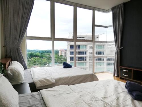 a bedroom with two beds and a large window at Ara Damansara Oasis Residence, Specious Home 4-8pax, 8min Subang Airport, 10min Sunway in Petaling Jaya