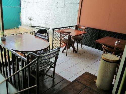 two tables and chairs on the balcony of a restaurant at Casa Leon Guesthouse in San José