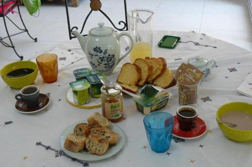 a table topped with plates of food and a tea pot at Le fief Beaurepaire 76280 in Beaurepaire