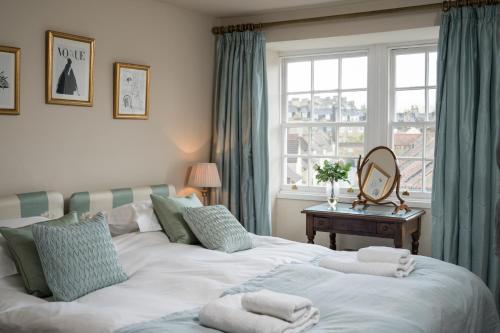 a bedroom with two beds with towels on them at Lady Margaret's in Bath