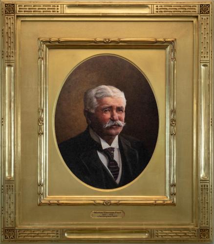a painting of a man in a suit in a gold frame at Belleview Inn in Belleair