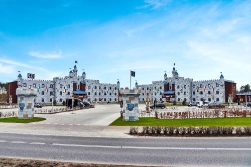 a large white building with a road in front of it at LEGOLAND Castle Hotel in Billund
