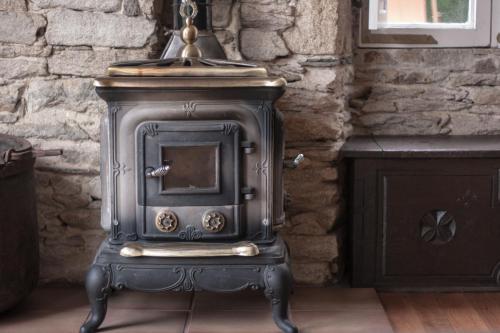 an old wood stove sitting in a room at CASA PELTRE in Sarria