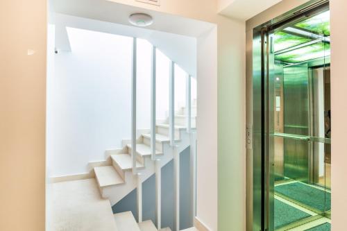 a staircase in a house with a glass door at Venis Boutique Hotel in Bucharest