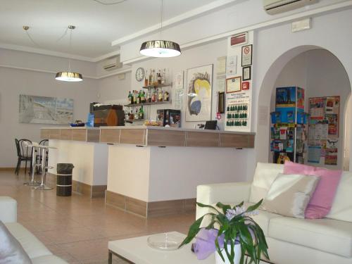 a living room with a couch and a counter at Hotel Amalfi in Rimini