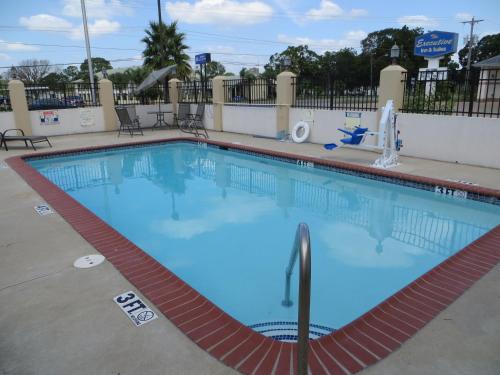 a swimming pool at a resort with blue water at Executive Inn & Suites West Columbia in West Columbia