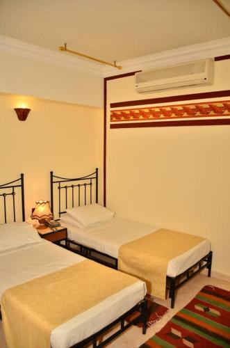 a room with two beds in a room at Dolphin Hotel Safaga in Safaga 
