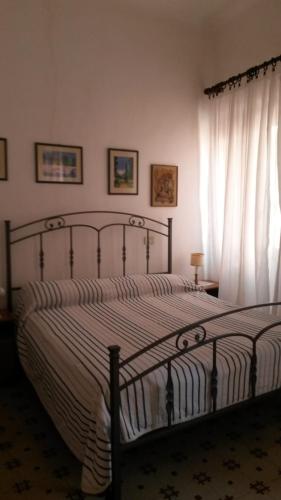 a bedroom with a bed and a window at Via Scappini in Rio Marina