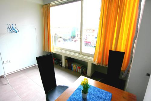 a dining room with a table and a window at SleepEasy in Athens