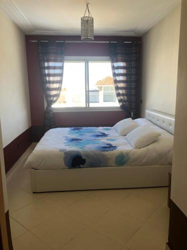 a bedroom with a bed with a dog laying on it at Asilah Marina Golf A3 in Asilah