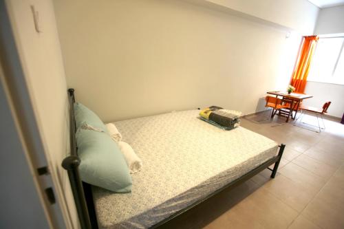 a bedroom with a bed and a table with a table at SleepEasy in Athens