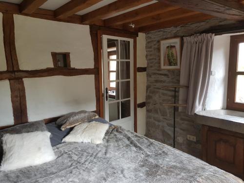 Postel nebo postele na pokoji v ubytování Ancien moulin de Vaux Chavanne