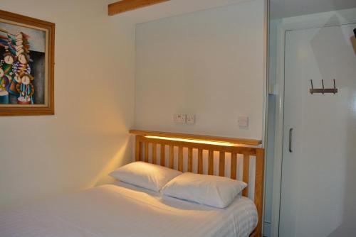 a bedroom with two beds and a door to a room at London Visitors Hotel in London