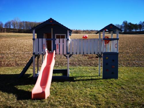 a playground with a slide and a play house at Ipfmühle Studio 2 (Weizen) in Hargelsberg