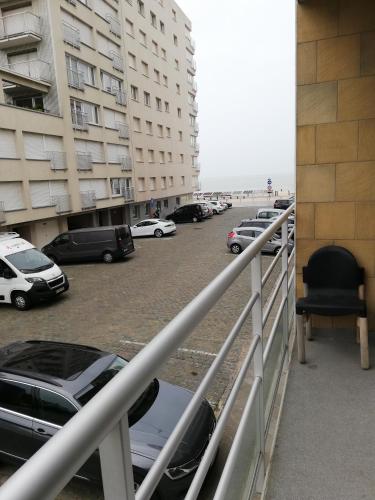 a balcony with cars parked in a parking lot at appartement oostende vlak bij zee in Ostend