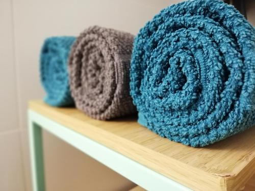 two towels sitting on a wooden shelf at appartement oostende vlak bij zee in Ostend