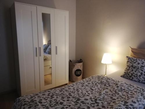 a bedroom with a bed and a closet with a mirror at appartement oostende vlak bij zee in Ostend