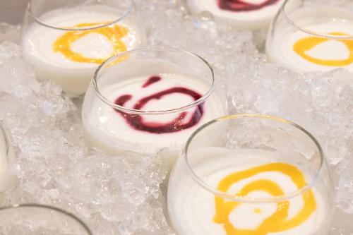 a group of glasses filled with dessert on ice at Boutique Hotel Sablon by CW Hotel Collection in Bruges
