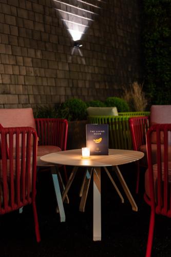 a table and chairs with a candle on it at Boutique Hotel Sablon by CW Hotel Collection in Bruges